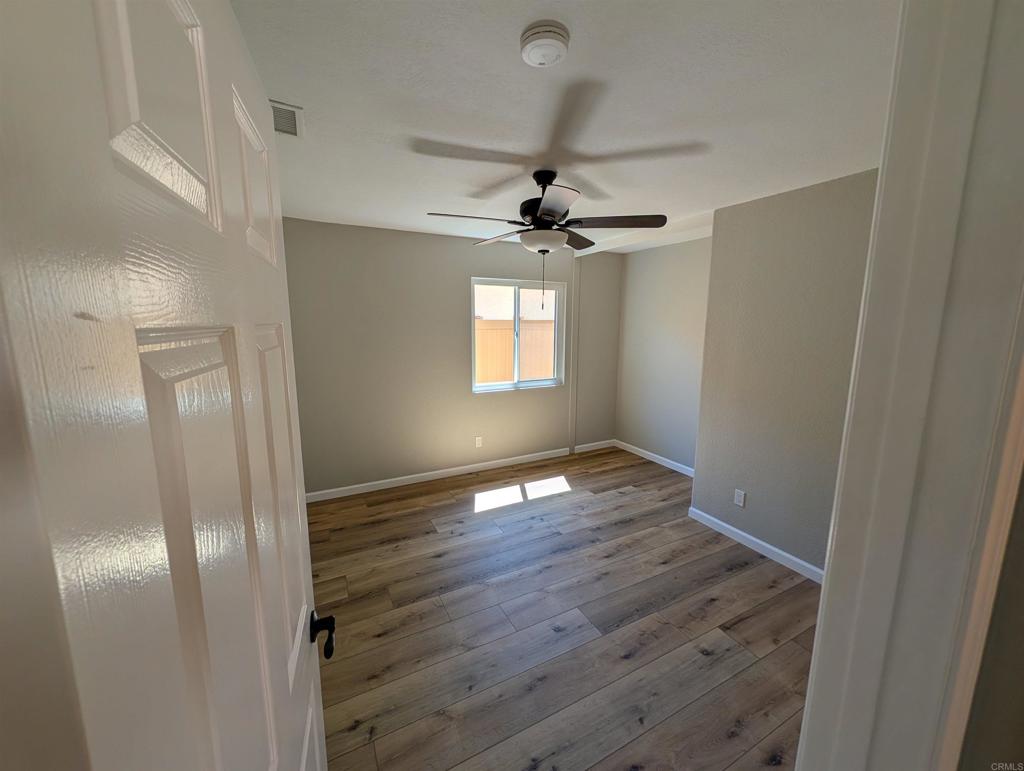 3752 Aries Escondido, CA 92025 - Photo 11 of 12 wooden floor in an empty room with a window