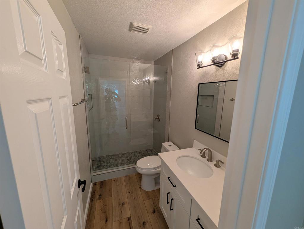 3752 Aries Escondido, CA 92025 - Photo 12 of 12 a bathroom with a sink toilet mirror and shower