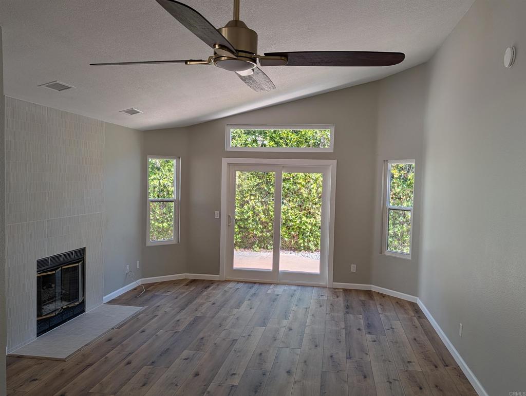 3752 Aries Escondido, CA 92025 - Photo 4 of 12 a view of an empty room with a window and wooden floor