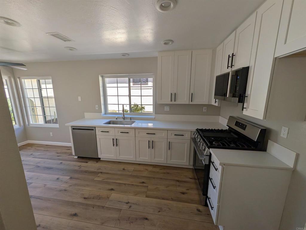 3752 Aries Escondido, CA 92025 - Photo 7 of 12 a kitchen with a stove and a sink