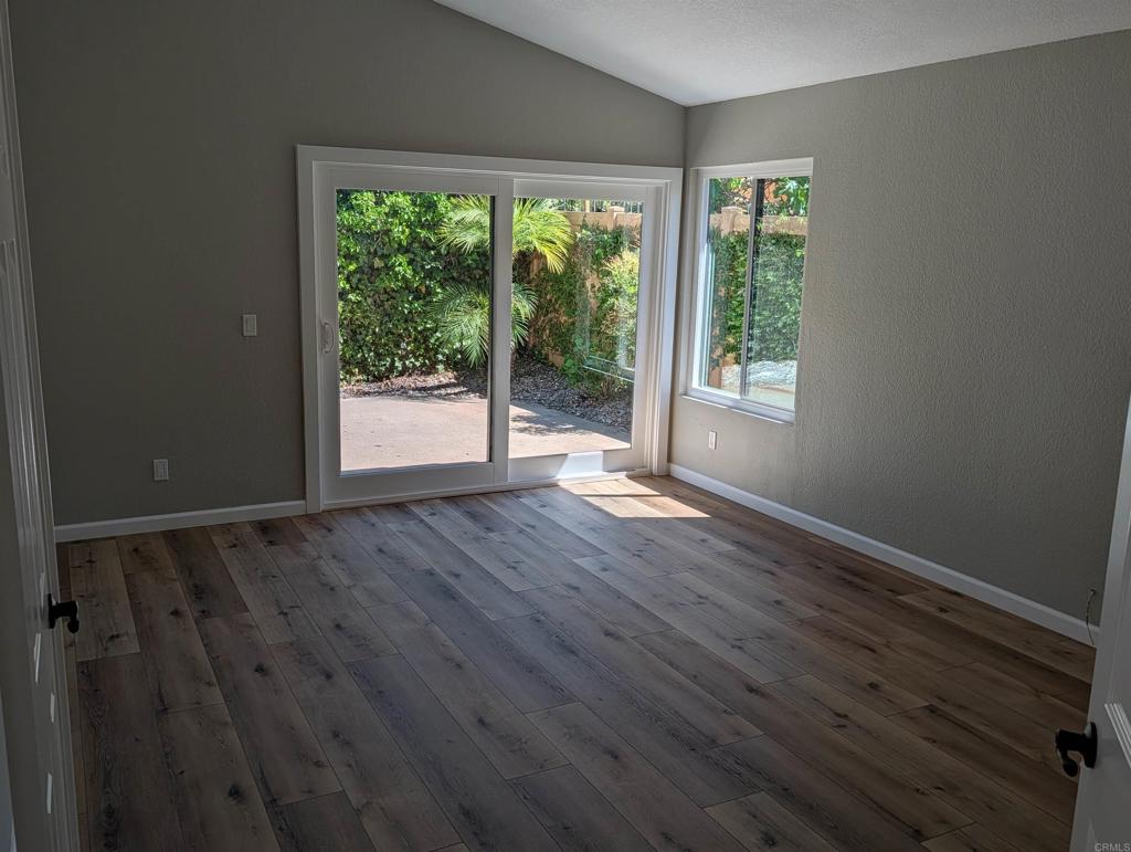 3752 Aries Escondido, CA 92025 - Photo 8 of 12 a view of an empty room with wooden floor and a window