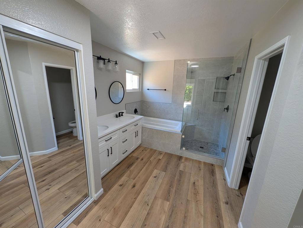 3752 Aries Escondido, CA 92025 - Photo 9 of 12 a bathroom with a sink a mirror and a shower