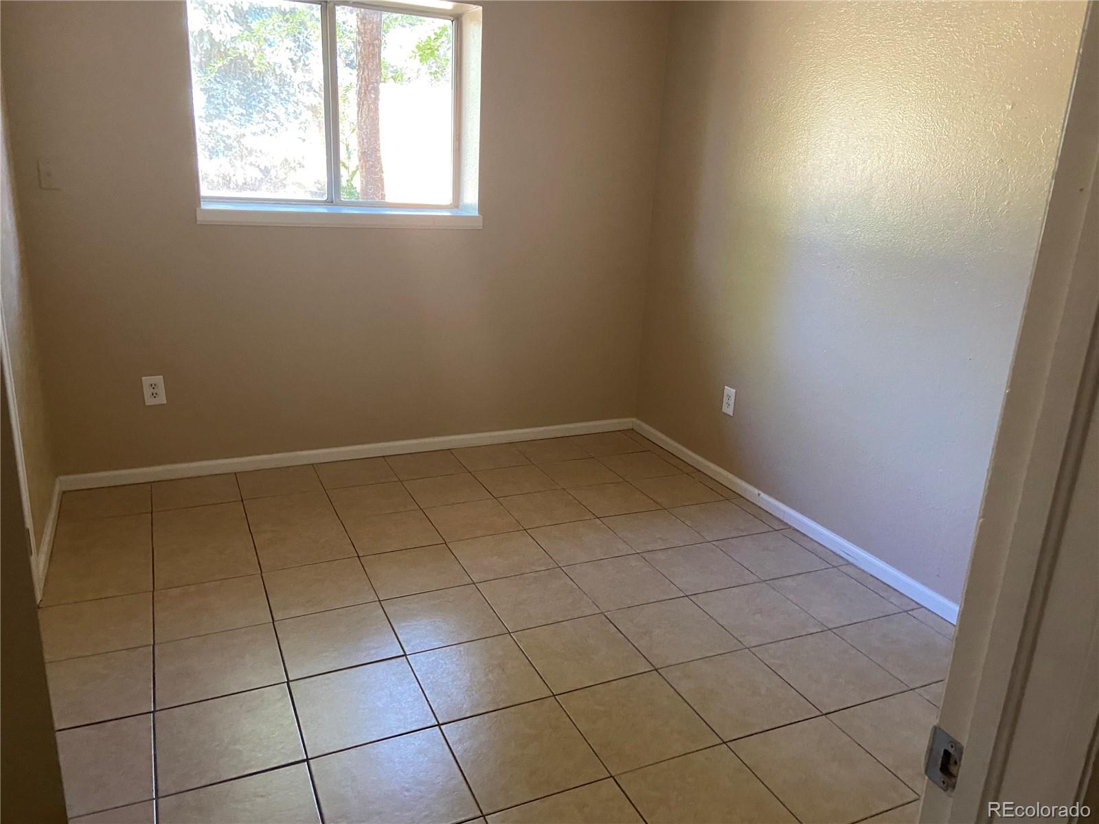 11123 Eudora Place Thornton, CO 80233 - Photo 17 of 26 an empty room with white walls and a window