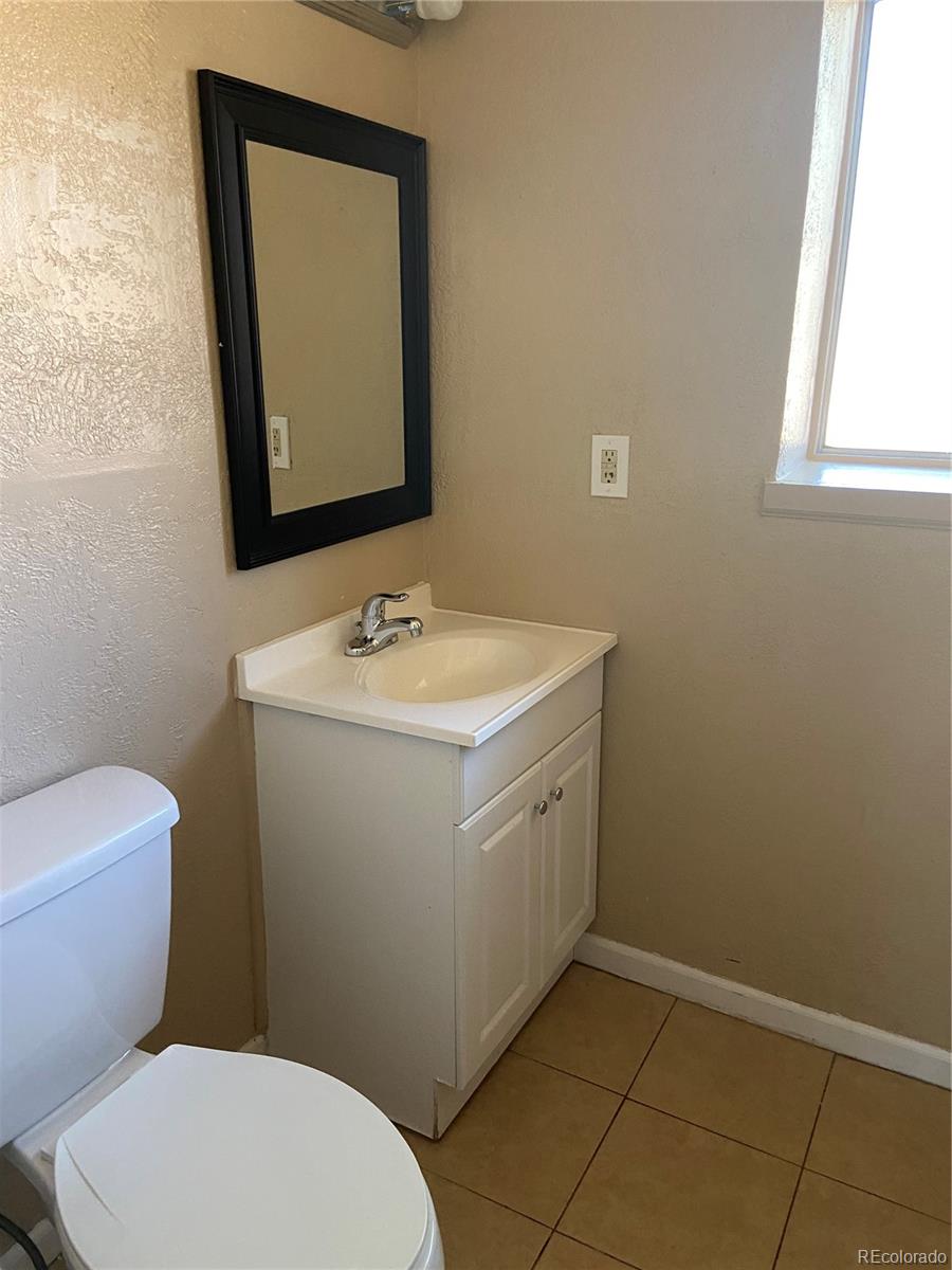 11123 Eudora Place Thornton, CO 80233 - Photo 18 of 26 a bathroom with a toilet sink and mirror