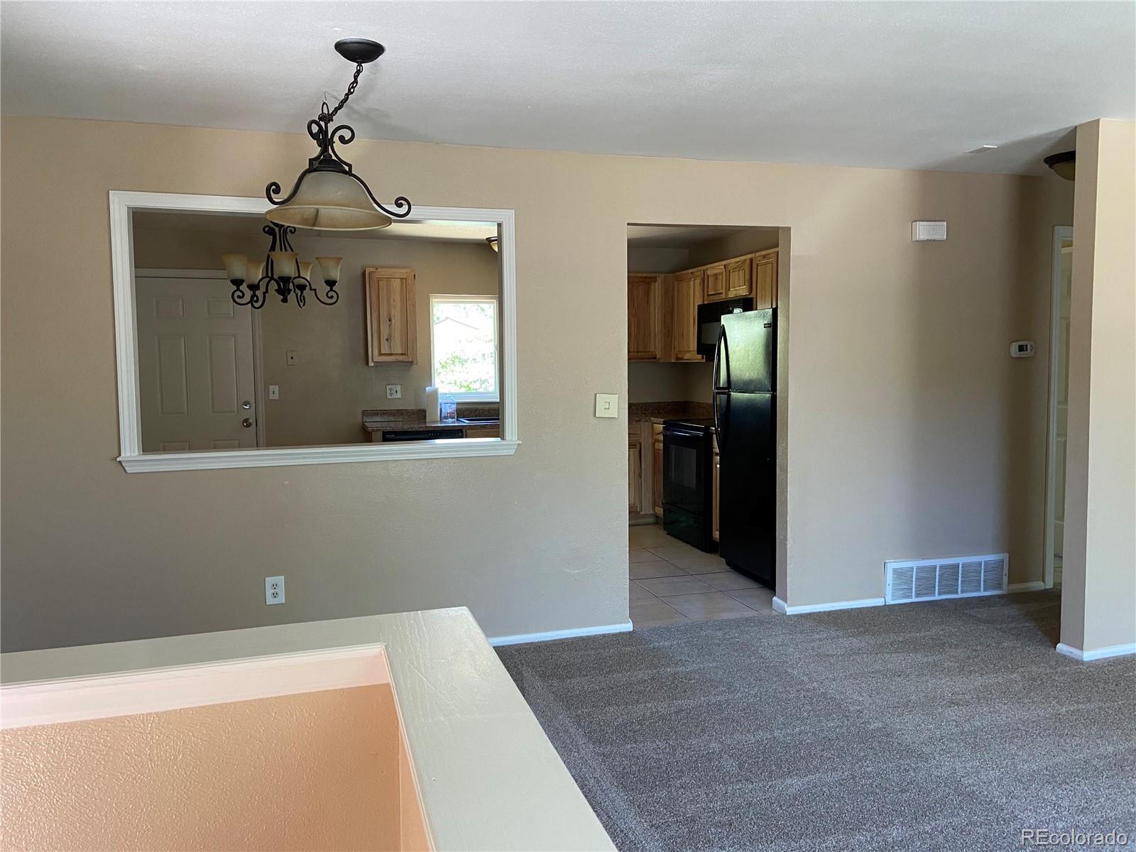 11123 Eudora Place Thornton, CO 80233 - Photo 3 of 26 a view of a hallway with a chandelier