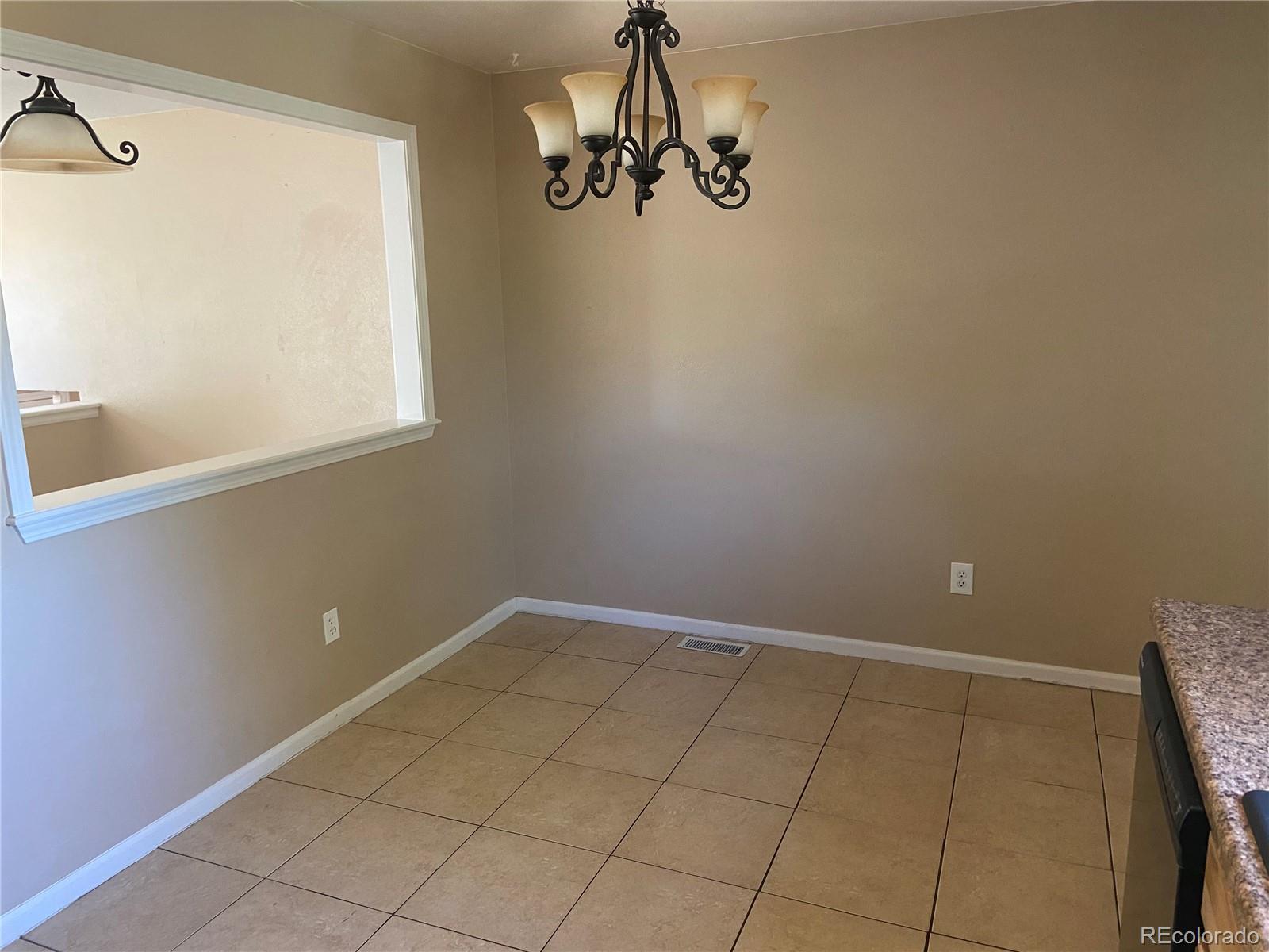 11123 Eudora Place Thornton, CO 80233 - Photo 5 of 26 a view of a room with rack on the wall and a window
