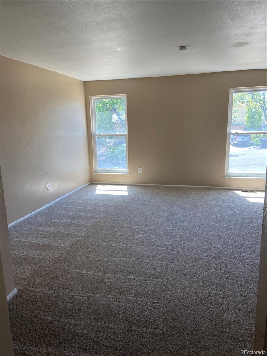 11123 Eudora Place Thornton, CO 80233 - Photo 7 of 26 an empty room with windows