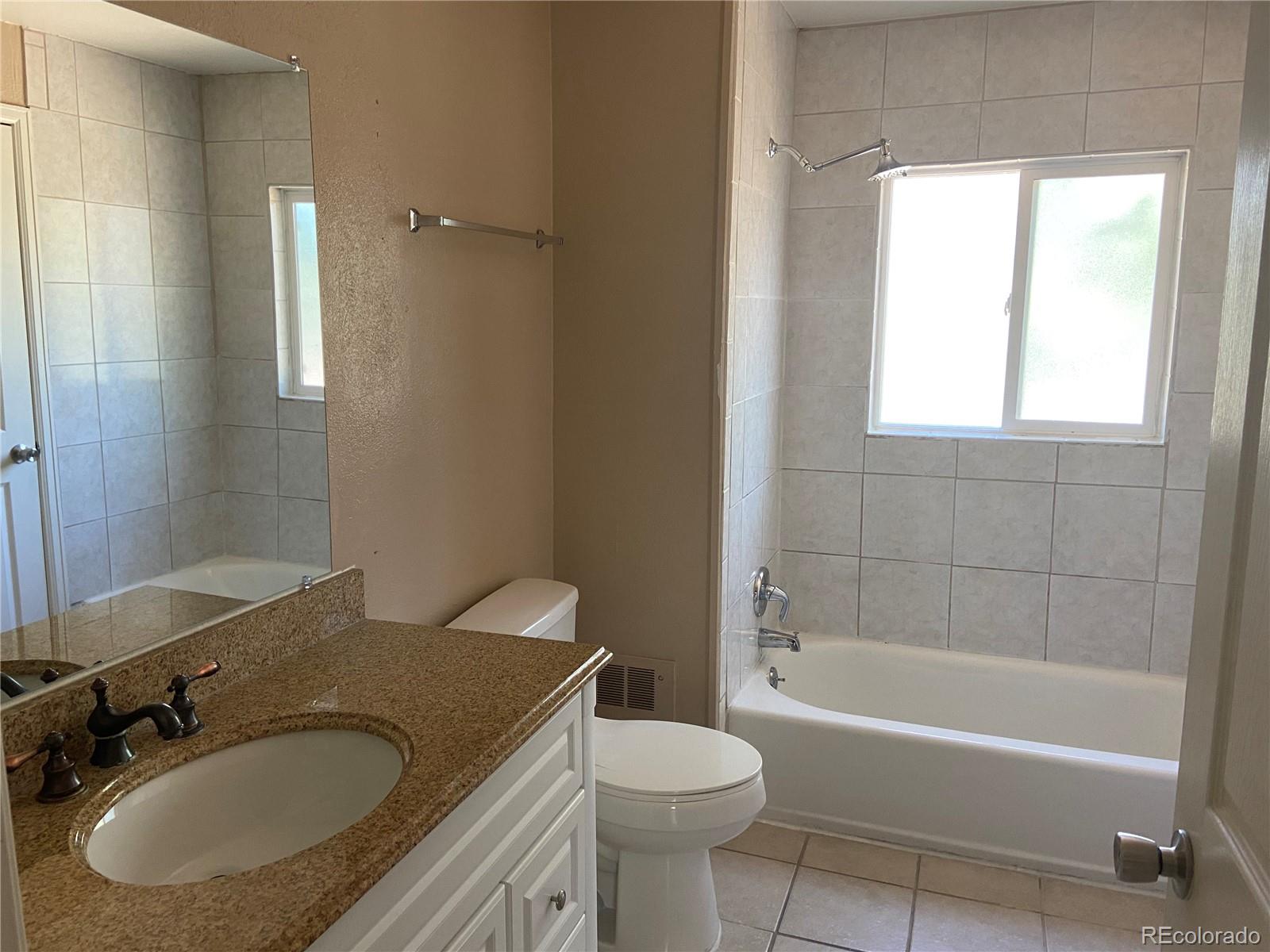 11123 Eudora Place Thornton, CO 80233 - Photo 8 of 26 a bathroom with a sink toilet and shower