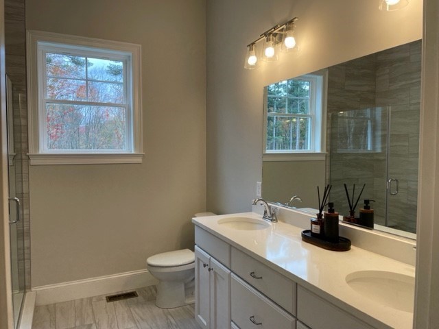 1 Shoemaker Lane, Unit 1 Upton, MA 01568 - Photo 5 of 6 a bathroom with a sink a toilet and with mirror