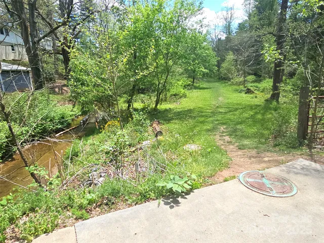a backyard of a house with a yard and fountain