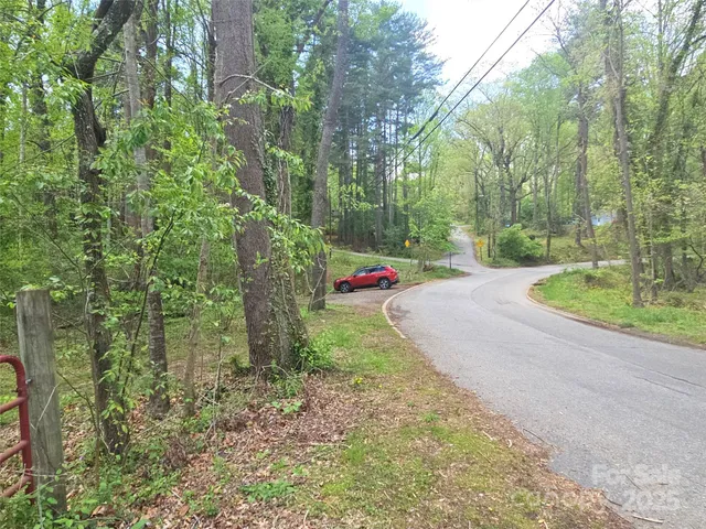 a small pool with lots of green space and trees