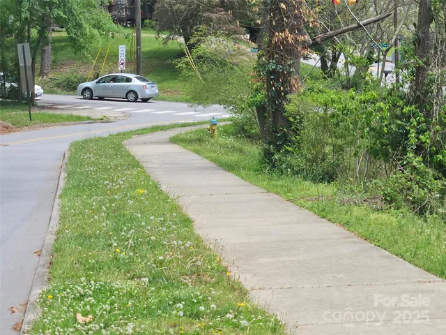 a front view of a house with a yard and fountain