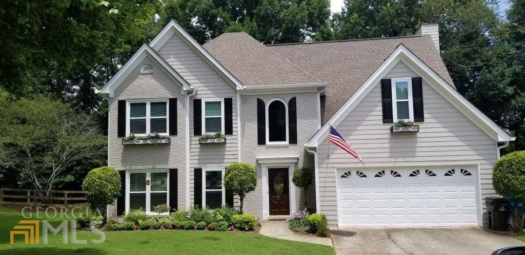 a view of a yard in front view of a house