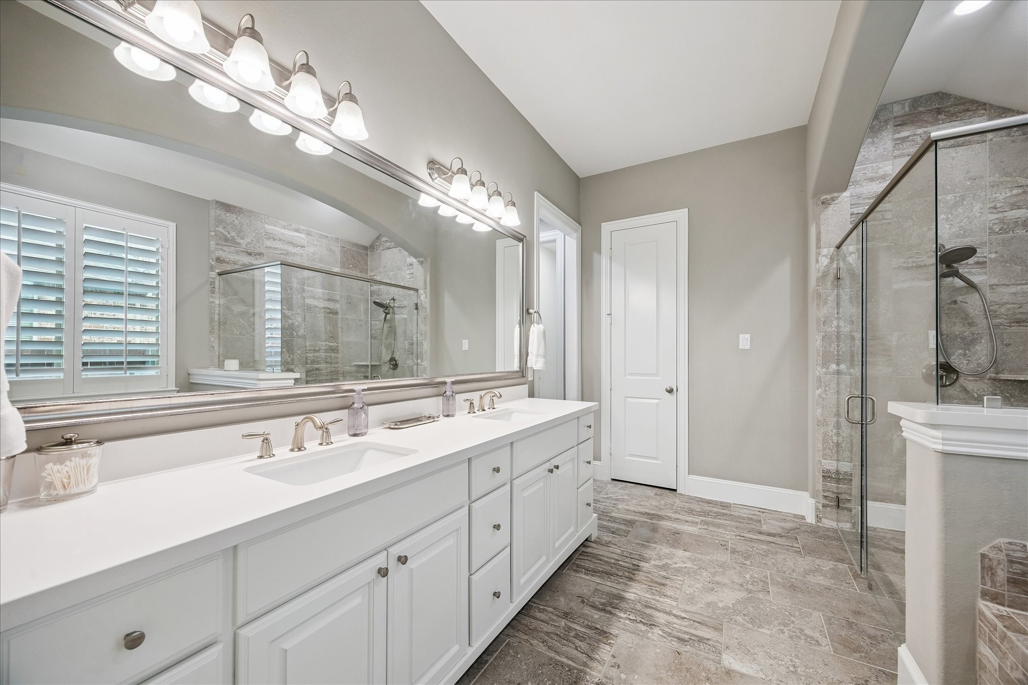 2807 Mayfield Ridge Lane Katy, TX 77494 - Photo 23 of 50 a spacious bathroom with a double vanity sink a large mirror and a shower