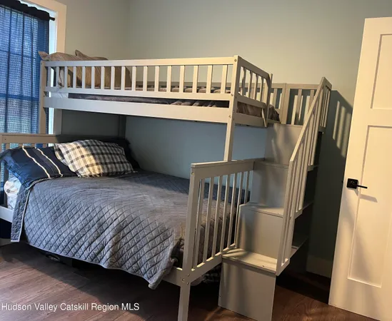 a bedroom with furniture and a window