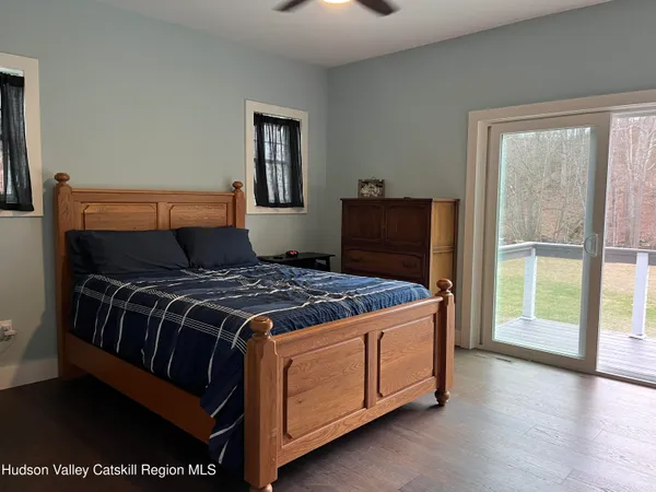 a bedroom with a bed next to a window
