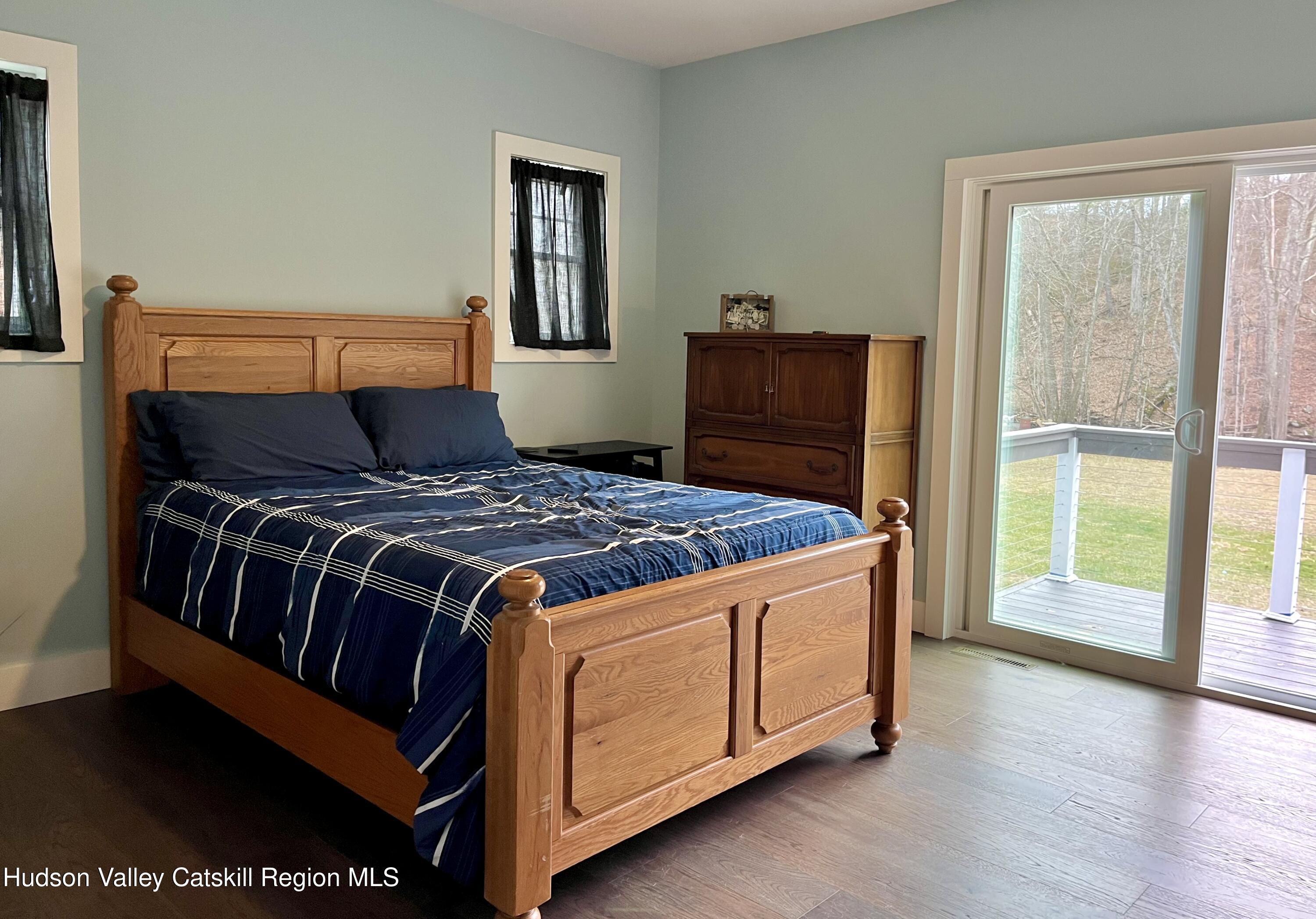 685 Sandy Plains Road Athens, NY 12451 - Photo 18 of 37 a bedroom with a bed and wooden floor