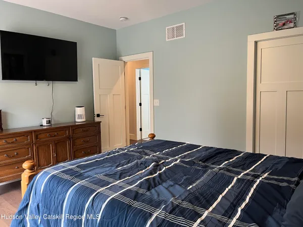 a bedroom with a bed and a flat screen tv