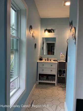 a bathroom with a sink vanity and mirror