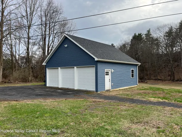 a view of a house with a yard and wooden fence