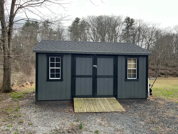 a view of house with yard and large trees