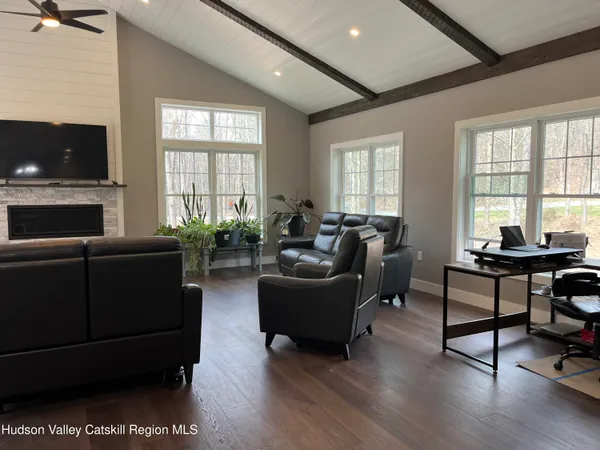 a living room with furniture a flat screen tv and a fireplace