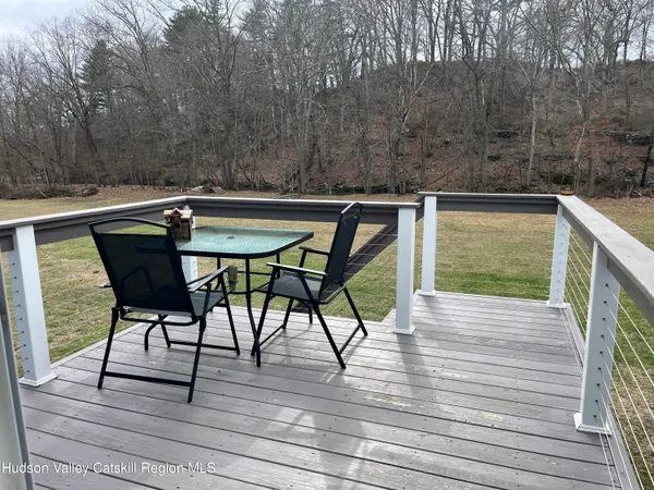 a view of balcony with wooden floor and outdoor seating