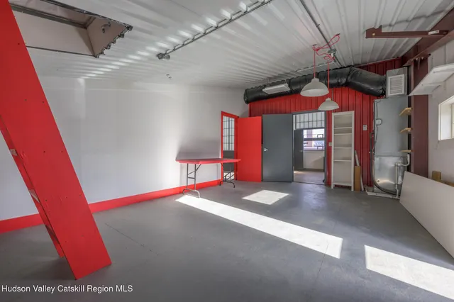 a view of an empty room with a fireplace