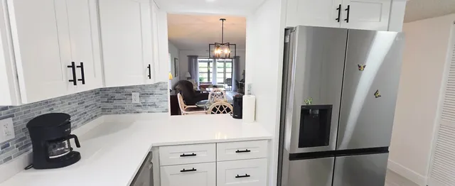 a kitchen with a refrigerator and a sink