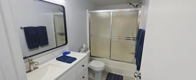 a bathroom with a sink toilet and shower