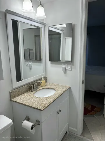 a bathroom with a granite countertop sink and a mirror