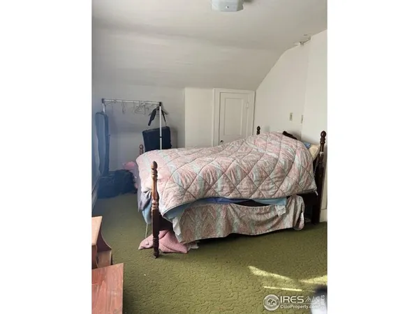 a bedroom with a bed and a closet