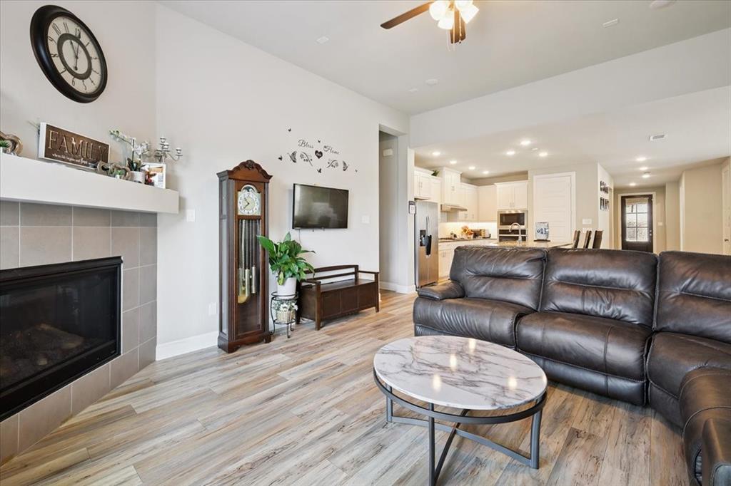 345 Greenbriar Road Little Elm, TX 75068 - Photo 6 of 20 Living area featuring recessed lighting, light wood finished floors, a tile fireplace, and a ceiling fan