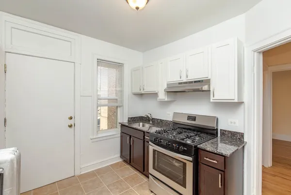 a kitchen with stainless steel appliances granite countertop a stove and a refrigerator