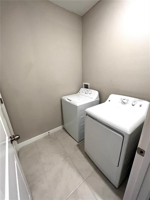 31657 Blue Passing Loop Wesley Chapel, FL 33545 - Photo 5 of 5 a utility room with dryer and washer