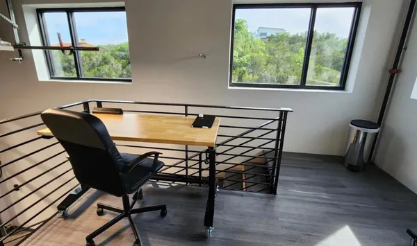 a view of a livingroom with furniture and a window
