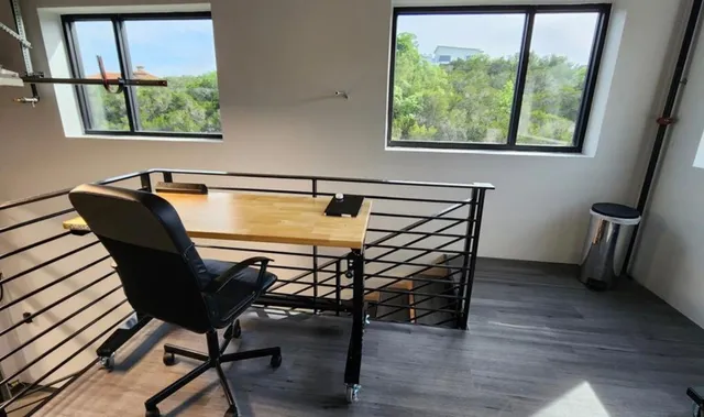 a view of a livingroom with furniture and a window