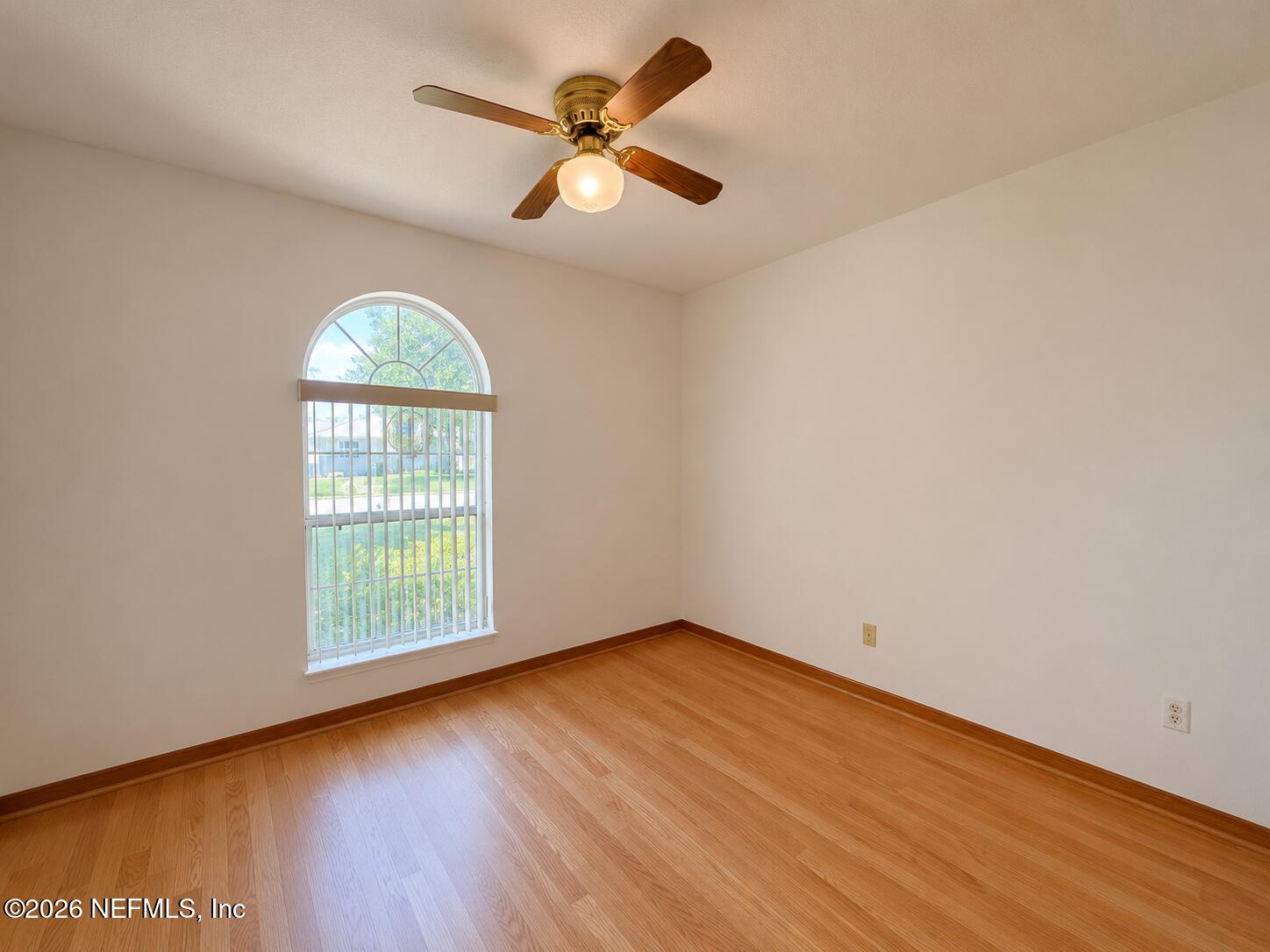 6 Surfcrest Street St. Augustine Beach, FL 32080 - Photo 13 of 15 an empty room with wooden floor chandelier fan and windows