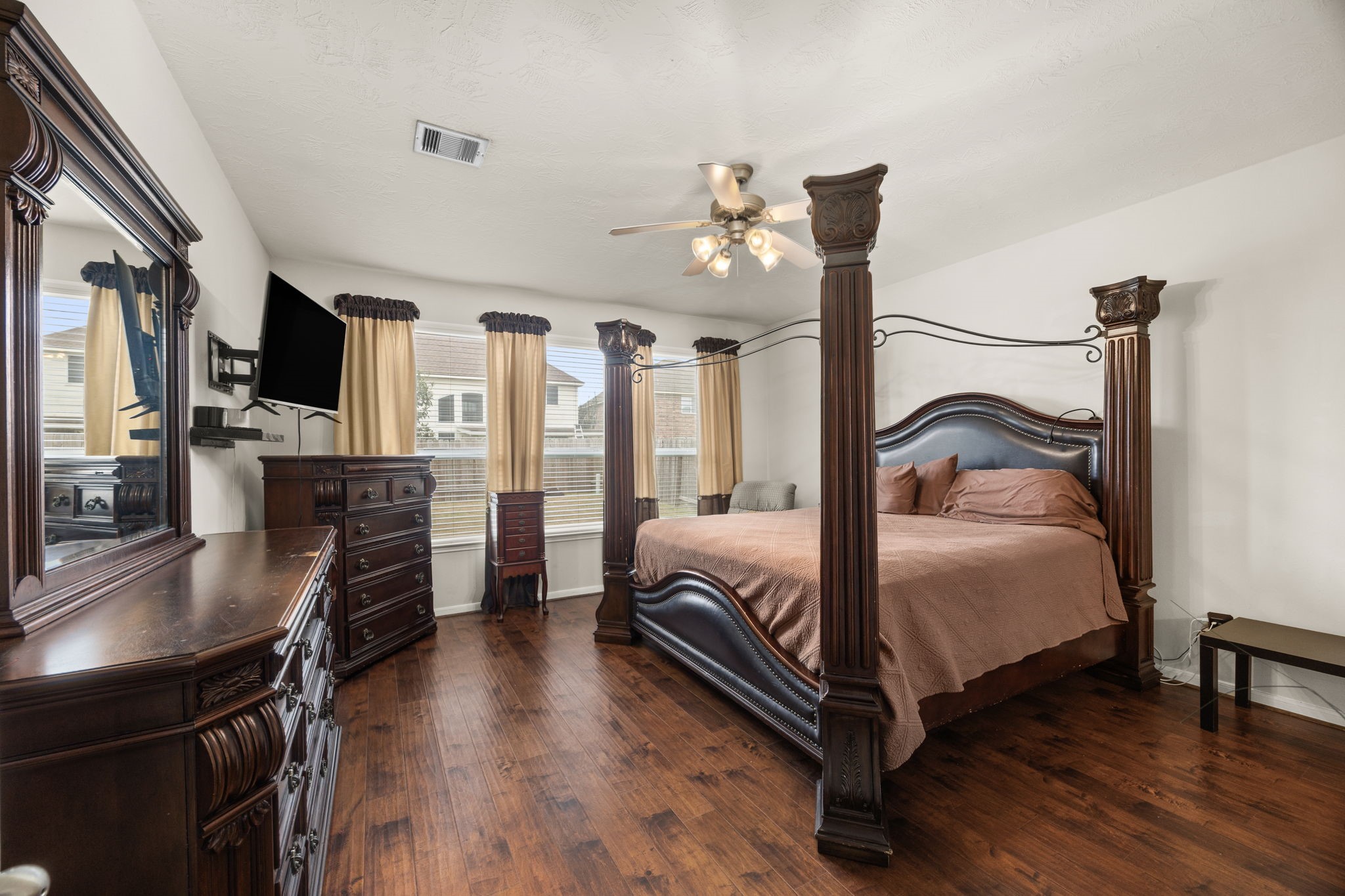 6719 Latchmore Lane Houston, TX 77049 - Photo 25 of 46 a bedroom with a bed and wooden floor