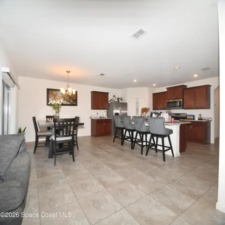 a living room with furniture and view of kitchen