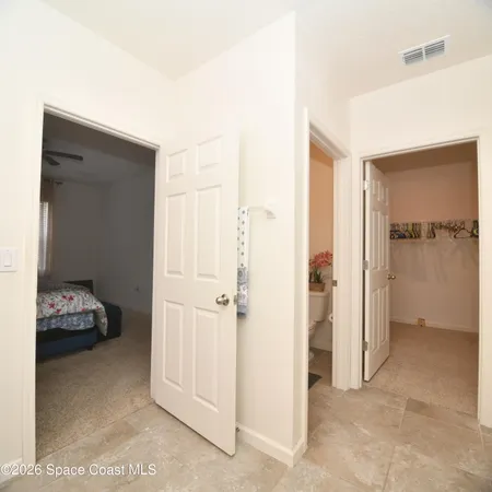 a white toilet sitting next to a white cabinet