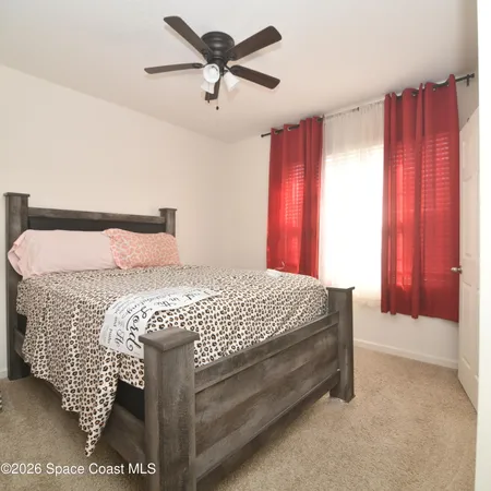 a bedroom with a bed and window