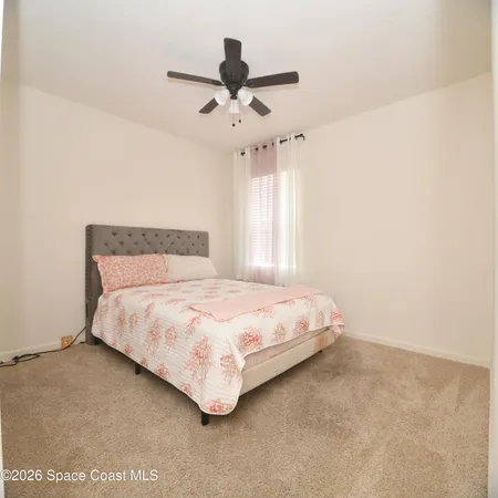 a bedroom with a bed and window