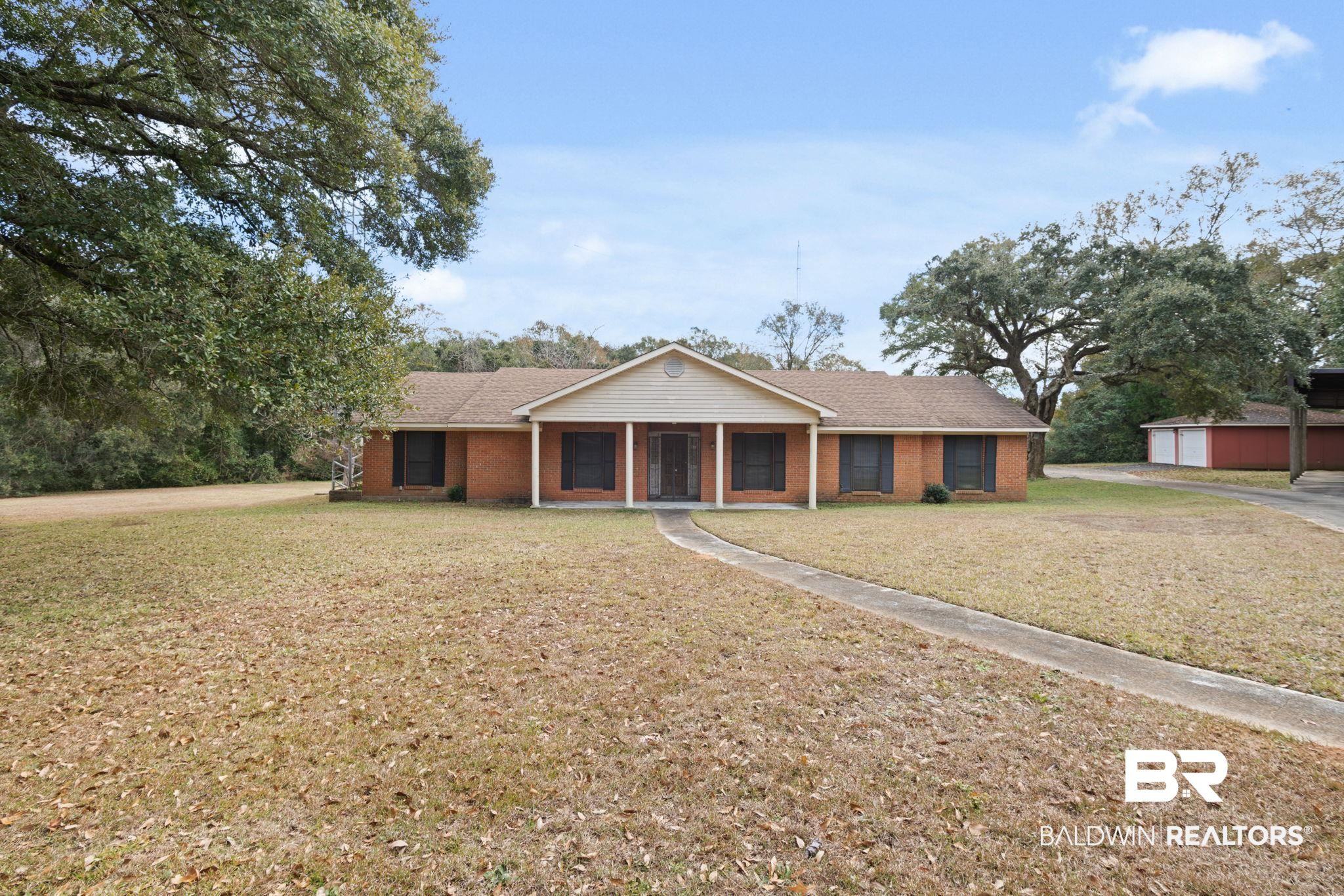 6261 Old Pascagoula Road Theodore, AL 36582 - Photo 2 of 29 Ranch-style house with covered porch and a front lawn