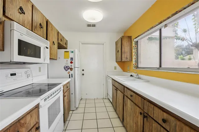 a kitchen with stainless steel appliances granite countertop a stove and a microwave