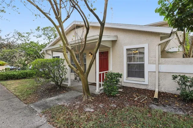 a house that has a tree in front of the house
