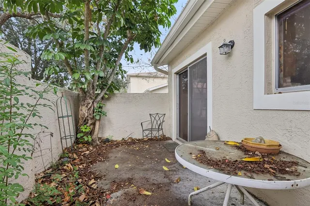 a backyard of a house with table and chairs