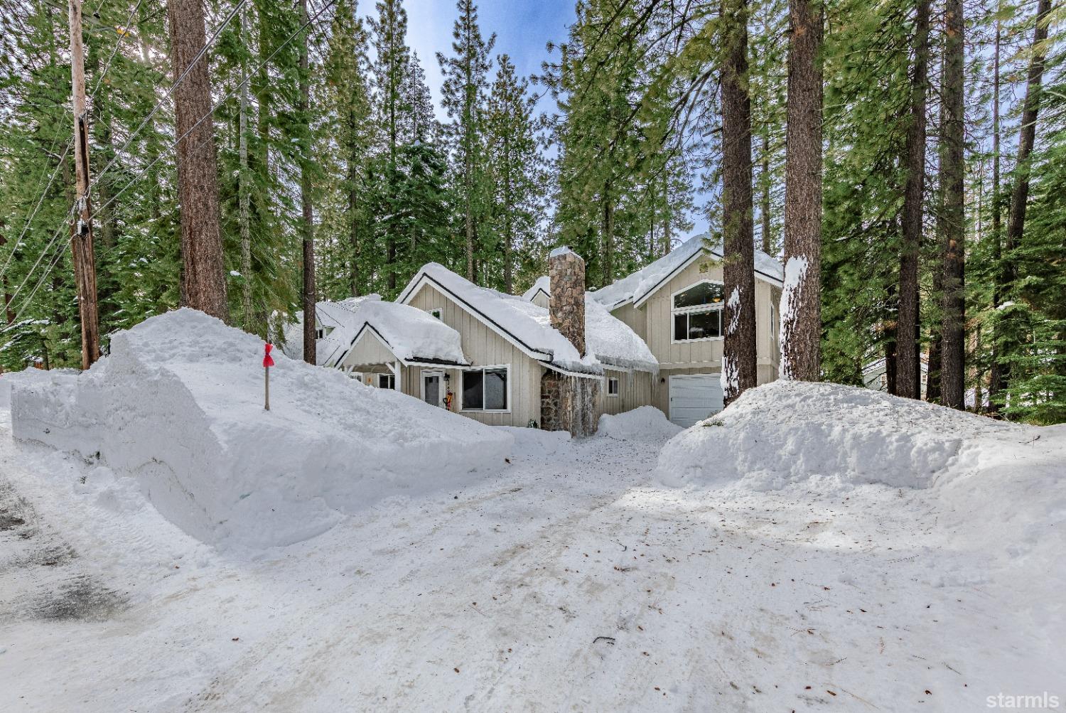 1254 Dedi Avenue South Lake Tahoe, CA 96150 - Photo 1 of 20 a white house that has a tree in front of it