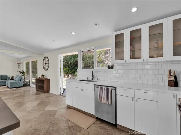 a kitchen with stainless steel appliances granite countertop a refrigerator sink and stove