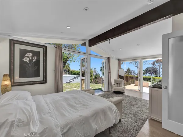 a spacious bedroom with a bed and a couch